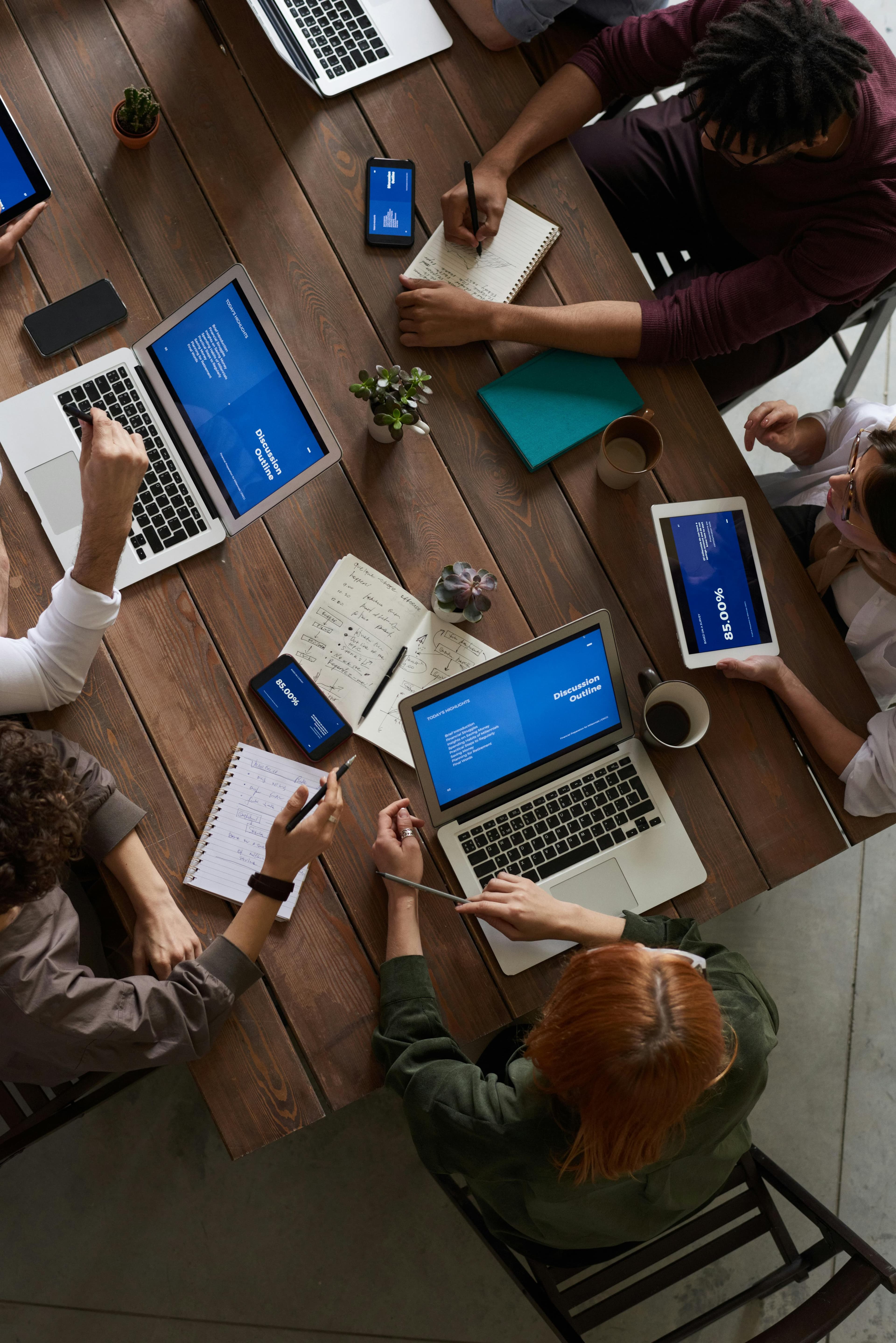 Equipe trabalhando em laptops em ambiente colaborativo